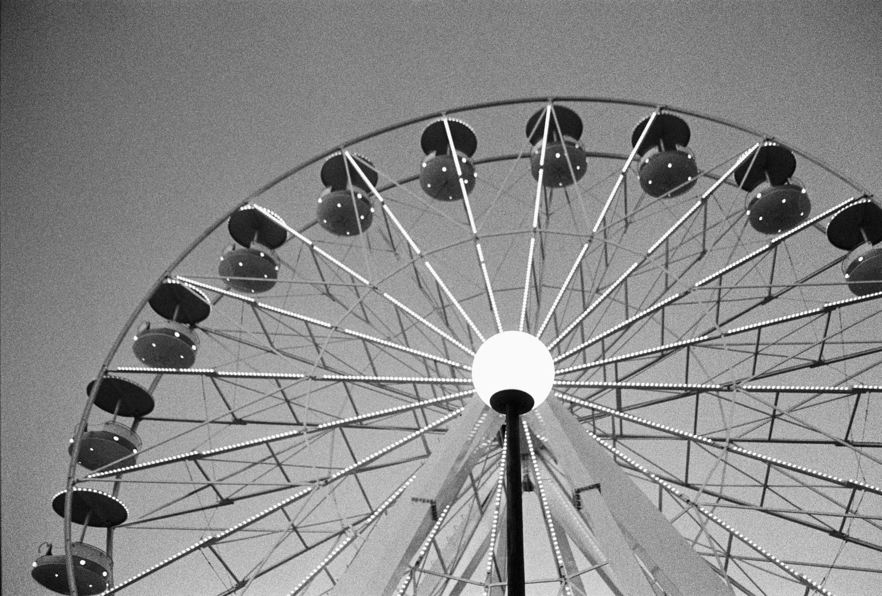 A Ferris wheel against a pale sky